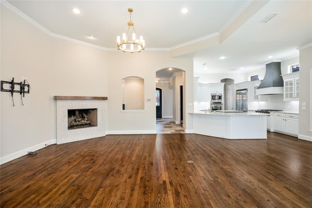 5116 Meadowside Lane Plano, TX 75093 - Photo 35 of 36 a view of empty room with wooden floor and fireplace