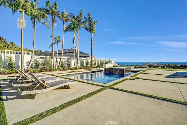 a view of swimming pool with chairs