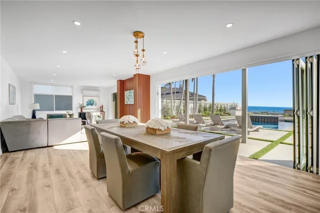 a dining hall with stainless steel appliances granite countertop a stove and a view of kitchen