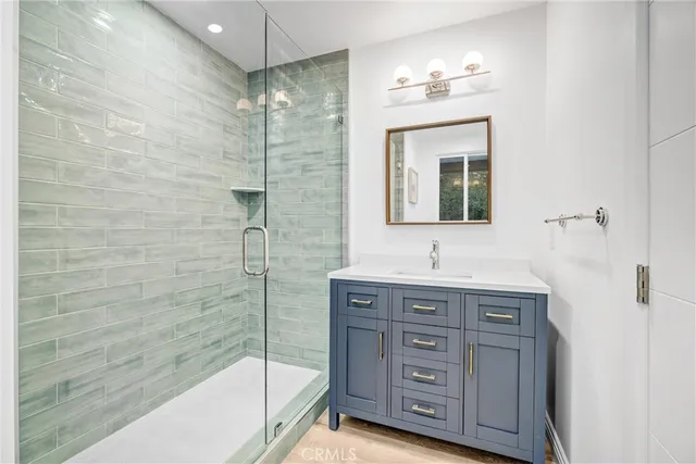 a bathroom with a granite countertop sink a mirror and a bathtub