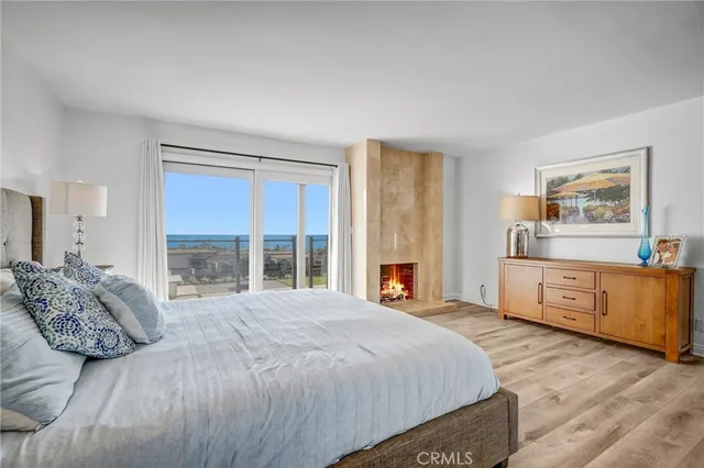 a spacious bedroom with a large bed and a dresser