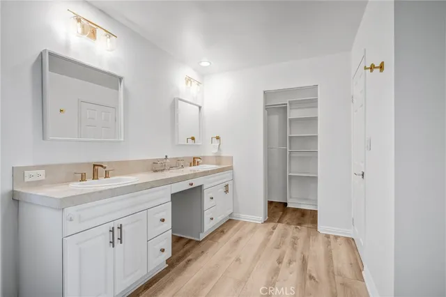 a spacious bathroom with a granite countertop sink mirror and