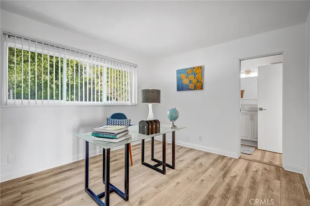 a view of a workspace with furniture and a window