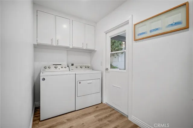 a utility room with sink dryer and washer
