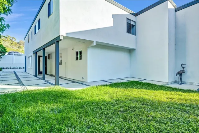 a backyard of a house with table and chairs