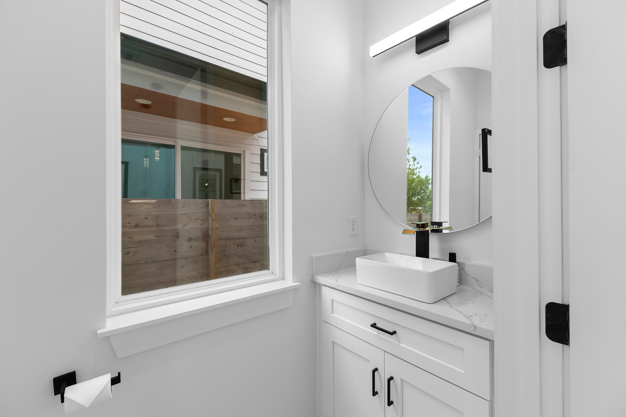 5305 Ledesma Road, Unit 4 Austin, TX 78721 - Photo 19 of 40 A well-lit primary bathroom vanity with contemporary fixtures and a window for natural illumination.