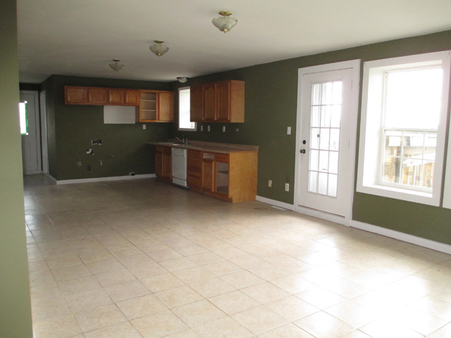 1953 Twist Road Franklin Grove, IL 61031 - Photo 4 of 16 a view of an empty room with a kitchen