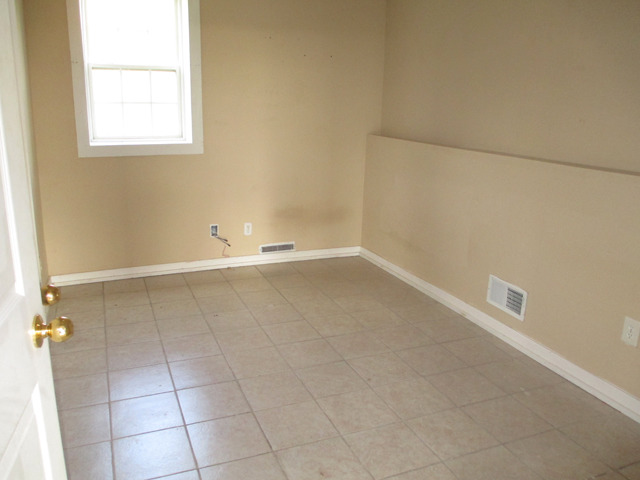 1953 Twist Road Franklin Grove, IL 61031 - Photo 9 of 16 an empty room with a white cabinet and a window