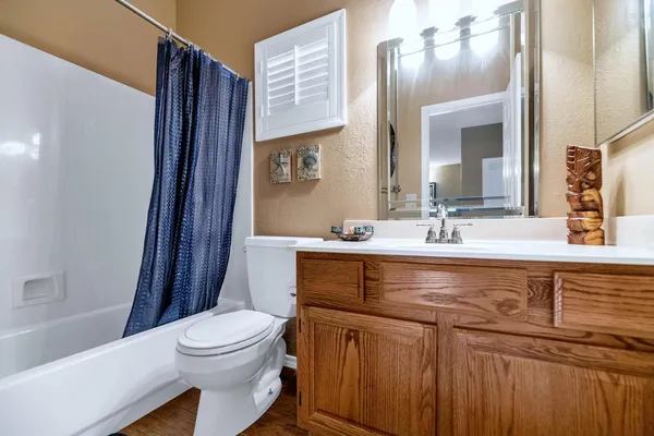 a bedroom with a bed and a ceiling fan