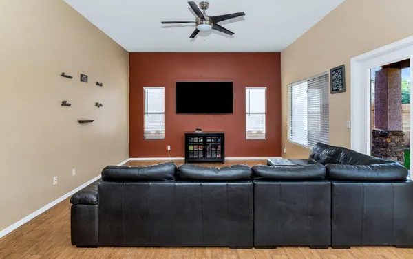 a view of a workspace with furniture and a window