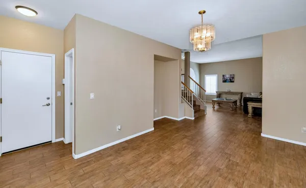 a kitchen with granite countertop a refrigerator stove top oven and sink