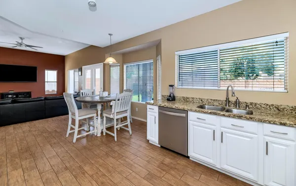 a kitchen with stainless steel appliances kitchen island granite countertop a refrigerator and microwave