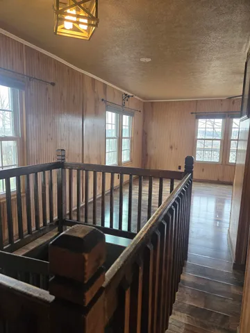 a front view of a house with wooden floor and windows