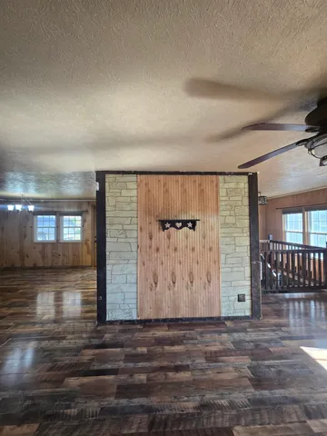 wooden floor in a hall with an entryway and a window