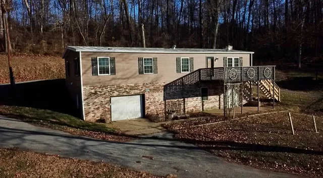a view of a house with backyard and sitting area