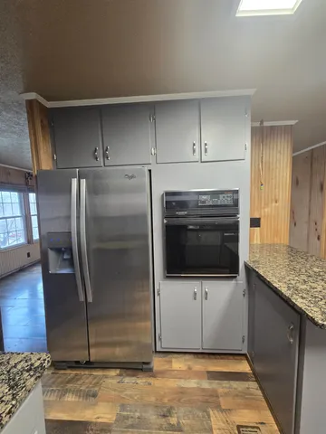 a kitchen with granite countertop a sink and a stove top oven