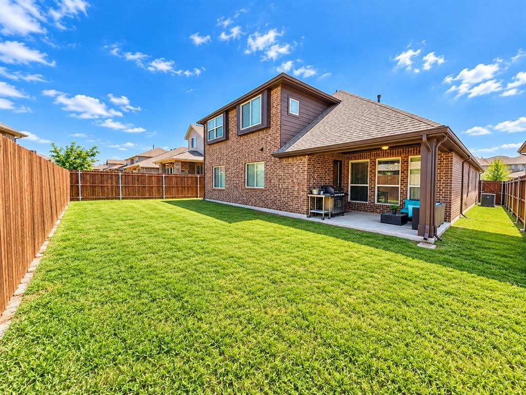 3301 Heathrow Road Mesquite, TX 75181 - Photo 24 of 26 Expansive green lawn, a covered patio, brick exterior, and a privacy fence