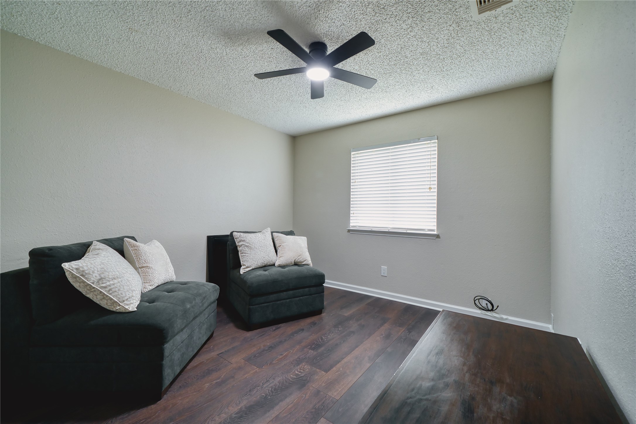 5402 Sherrylee Lane Spring, TX 77373 - Photo 14 of 21 The second bedroom featuring dark wood floors and neutral walls. With it's natural light it creates a versatile space perfect for an office, reading nook, or guest room.