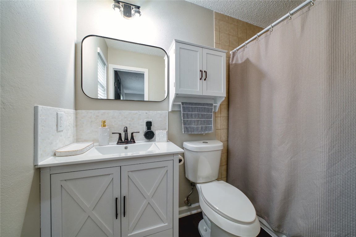 5402 Sherrylee Lane Spring, TX 77373 - Photo 19 of 24 Master bathroom with a modern vanity and ample storage, sleek mirror, and updated fixtures. A wall-mounted cabinet adds both style and functionality in this well-designed space.