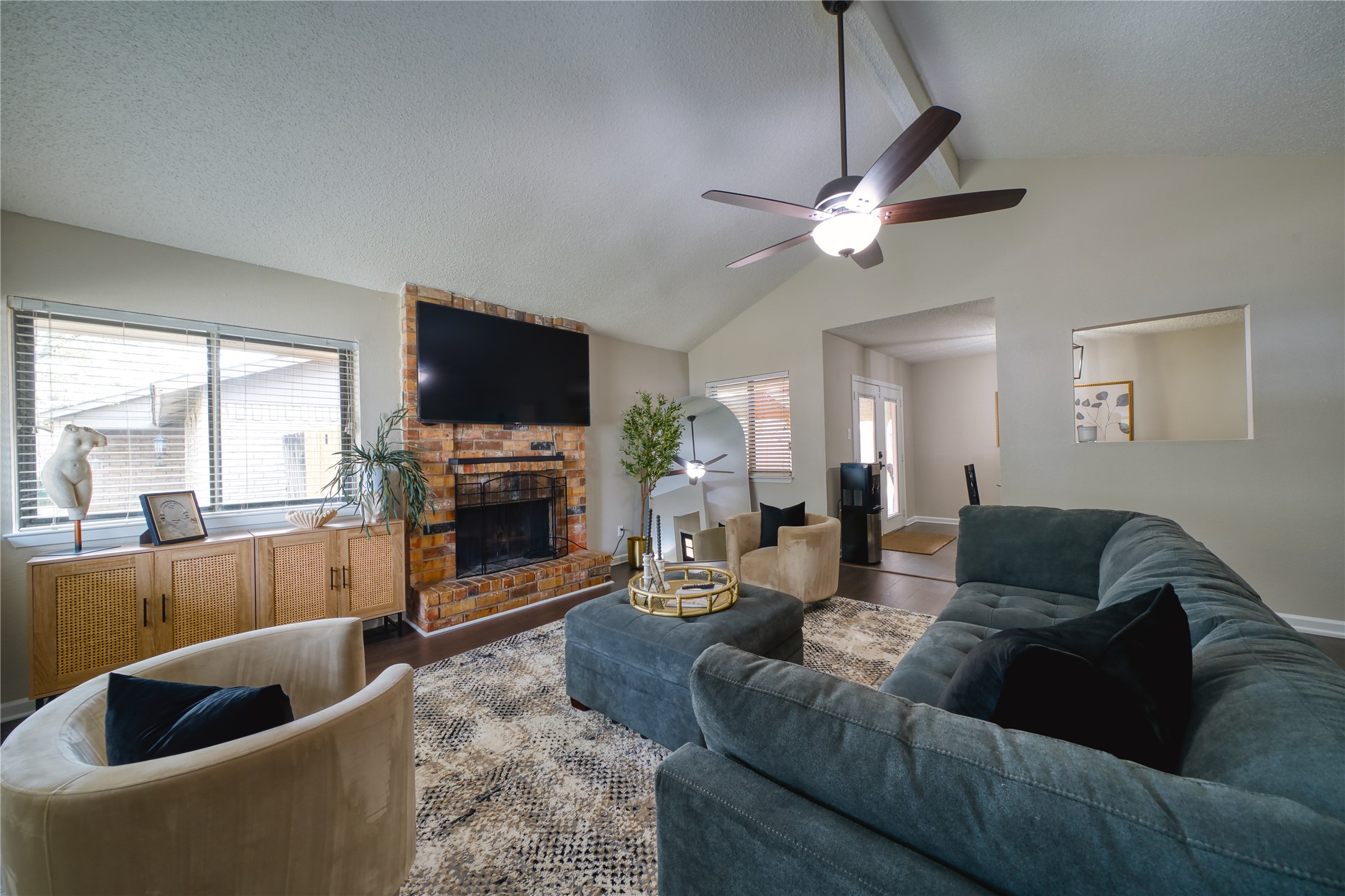 5402 Sherrylee Lane Spring, TX 77373 - Photo 3 of 21 Spacious living room with soaring vaulted ceilings and a cozy brick fireplace. Large windows fill the space with natural light.