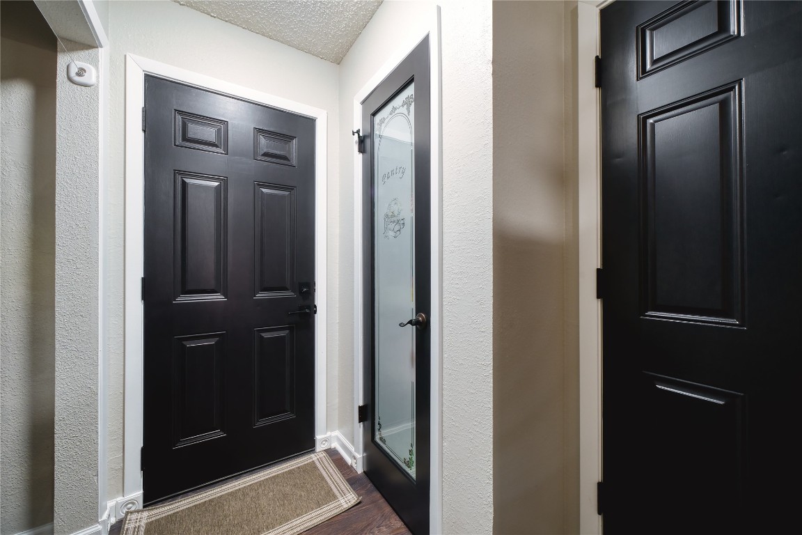 5402 Sherrylee Lane Spring, TX 77373 - Photo 9 of 24 Light-filled hallway connecting the side yard, pantry, and garage, offering convenient access and a smooth flow through the home.