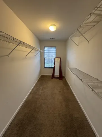 a view of a room with window and hardwood floor