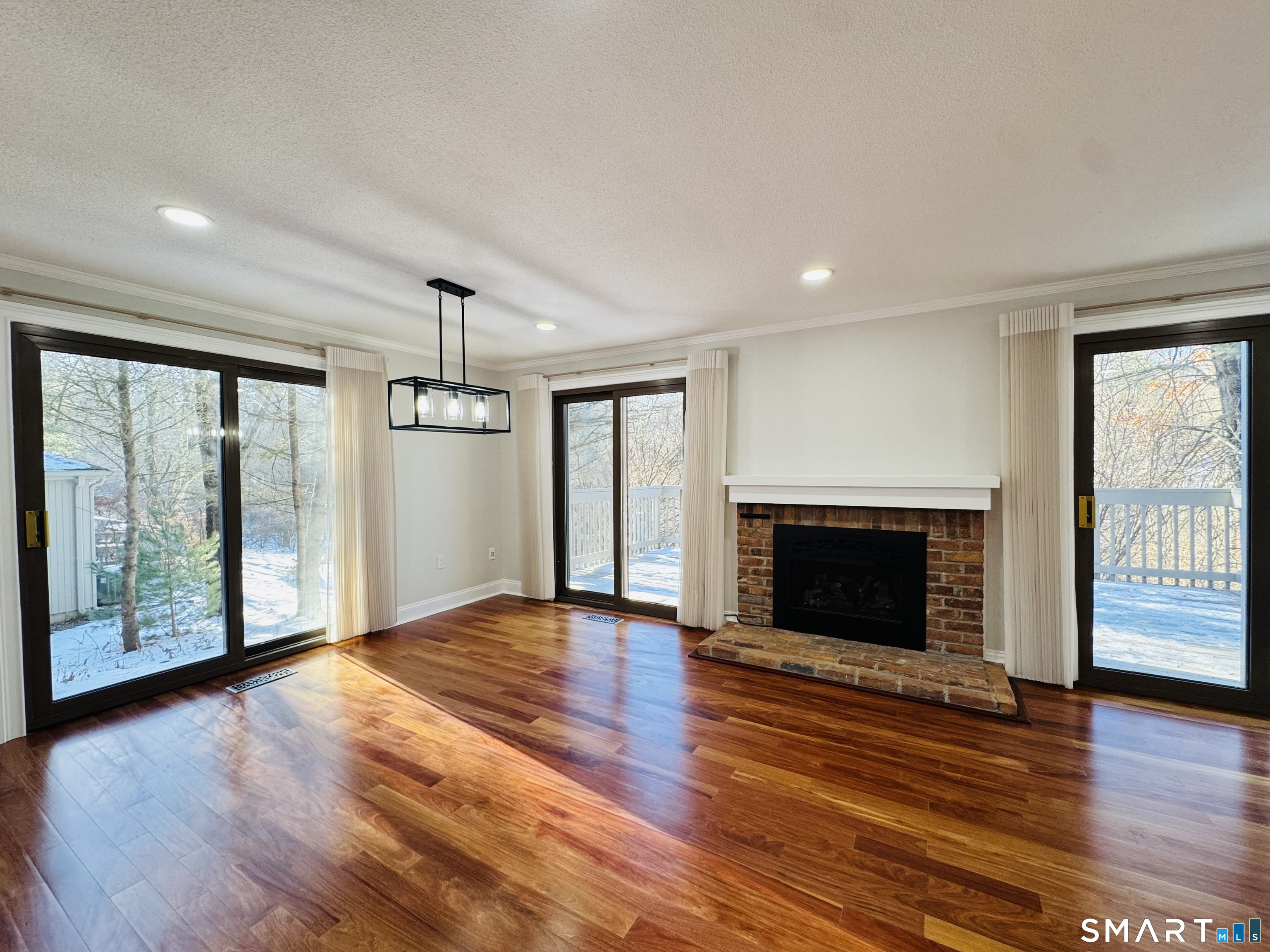 2 Highland Square, Unit 2 Avon, CT 06001 - Photo 13 of 40 a view of an empty room with wooden floor and a window