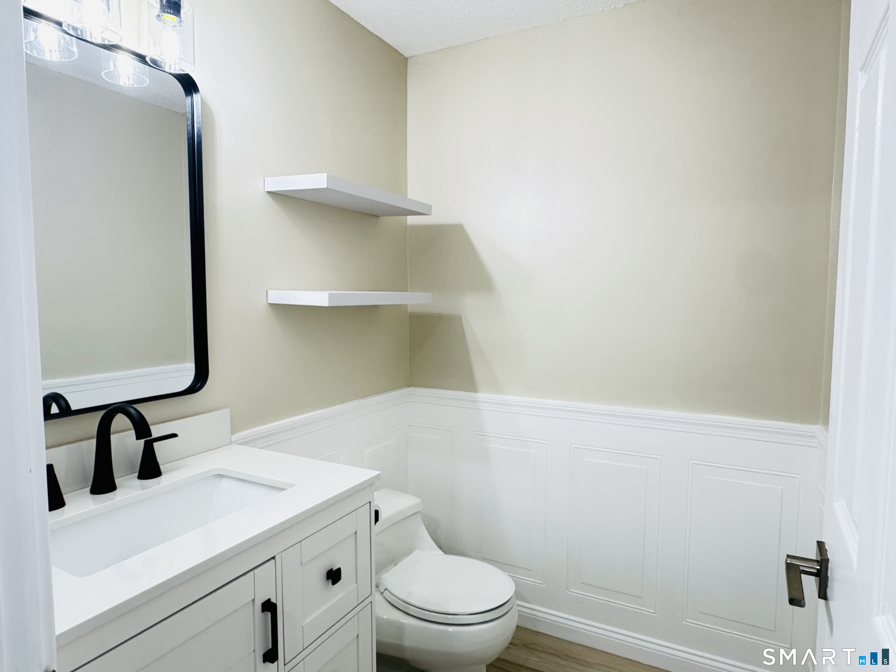 2 Highland Square, Unit 2 Avon, CT 06001 - Photo 17 of 40 a bathroom with a sink a toilet and vanity
