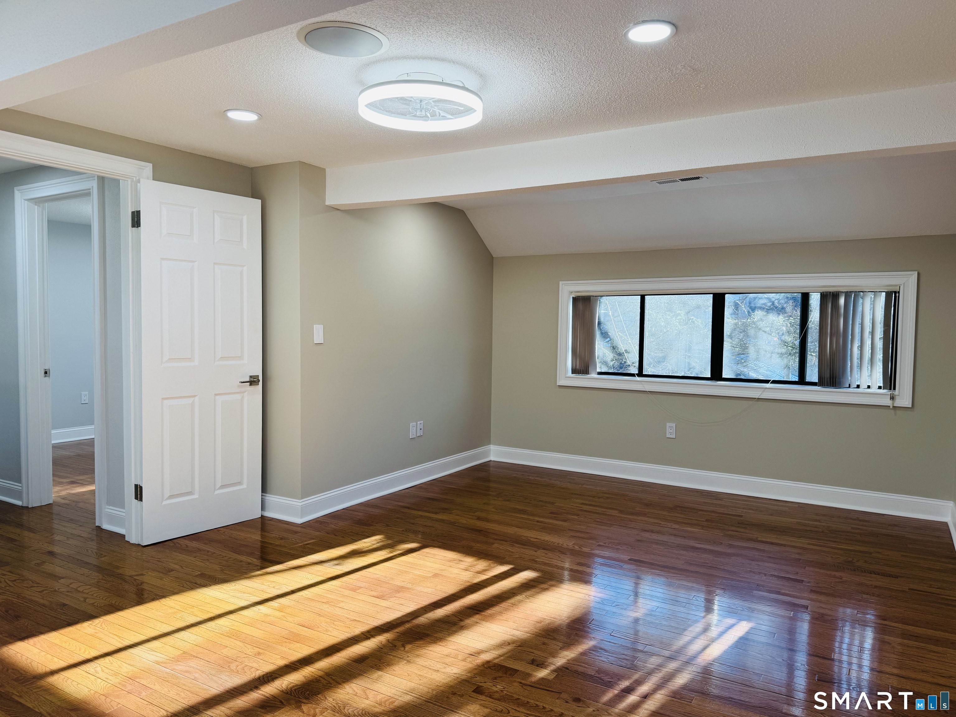 2 Highland Square, Unit 2 Avon, CT 06001 - Photo 22 of 40 a view of empty room with wooden floor and fan