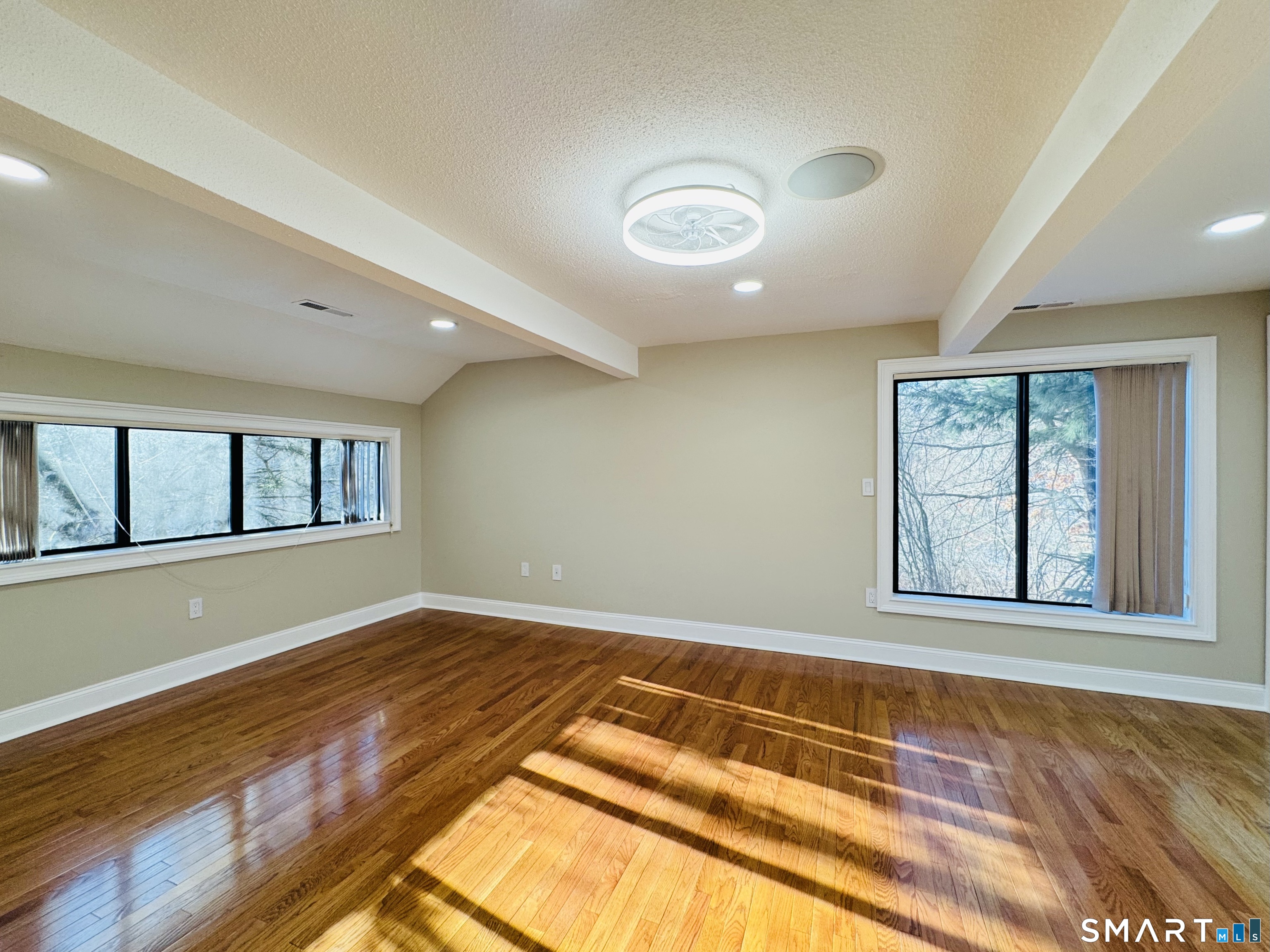 2 Highland Square, Unit 2 Avon, CT 06001 - Photo 23 of 40 an empty room with wooden floor and windows