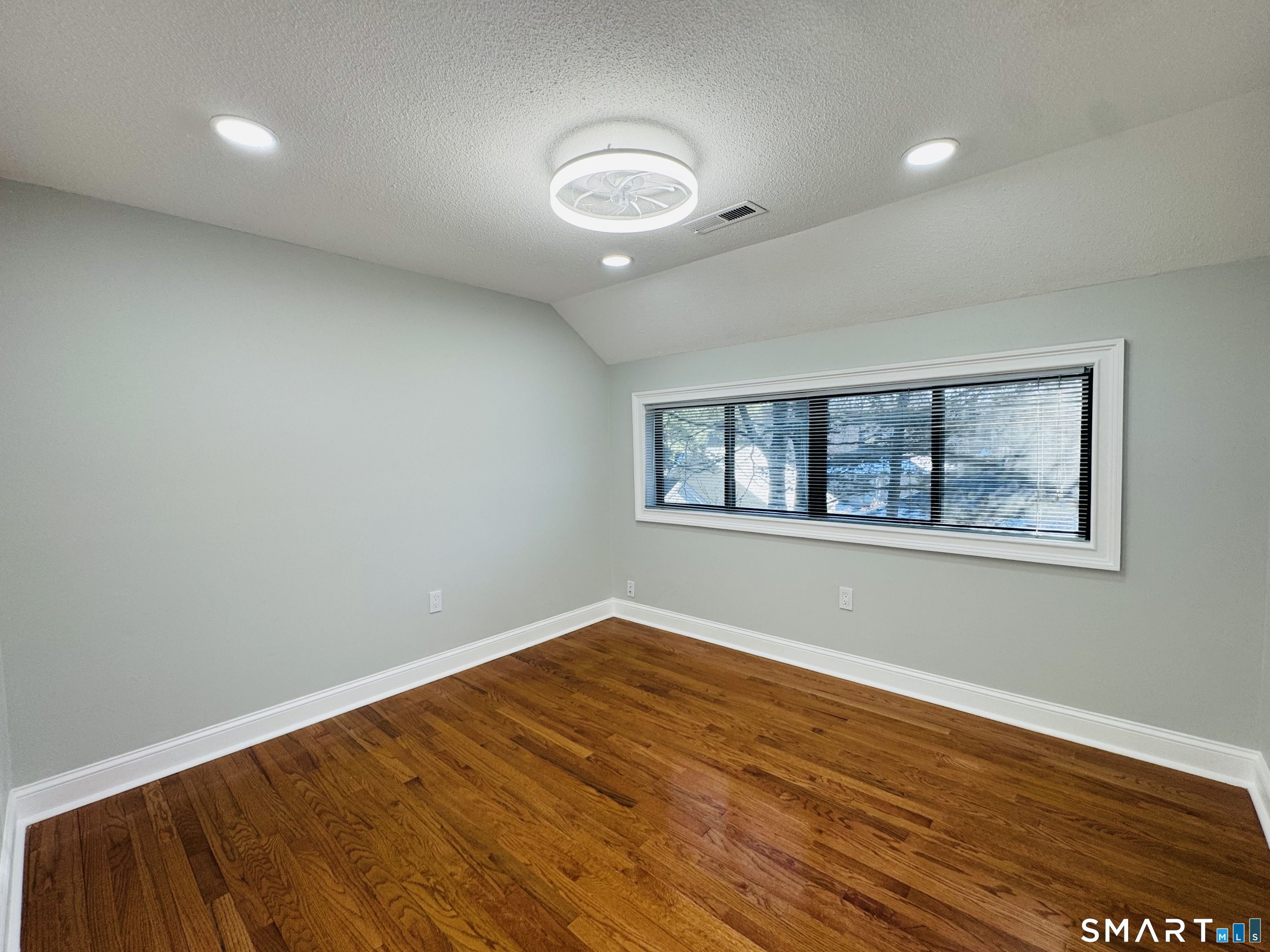 2 Highland Square, Unit 2 Avon, CT 06001 - Photo 32 of 40 an empty room with wooden floor and windows