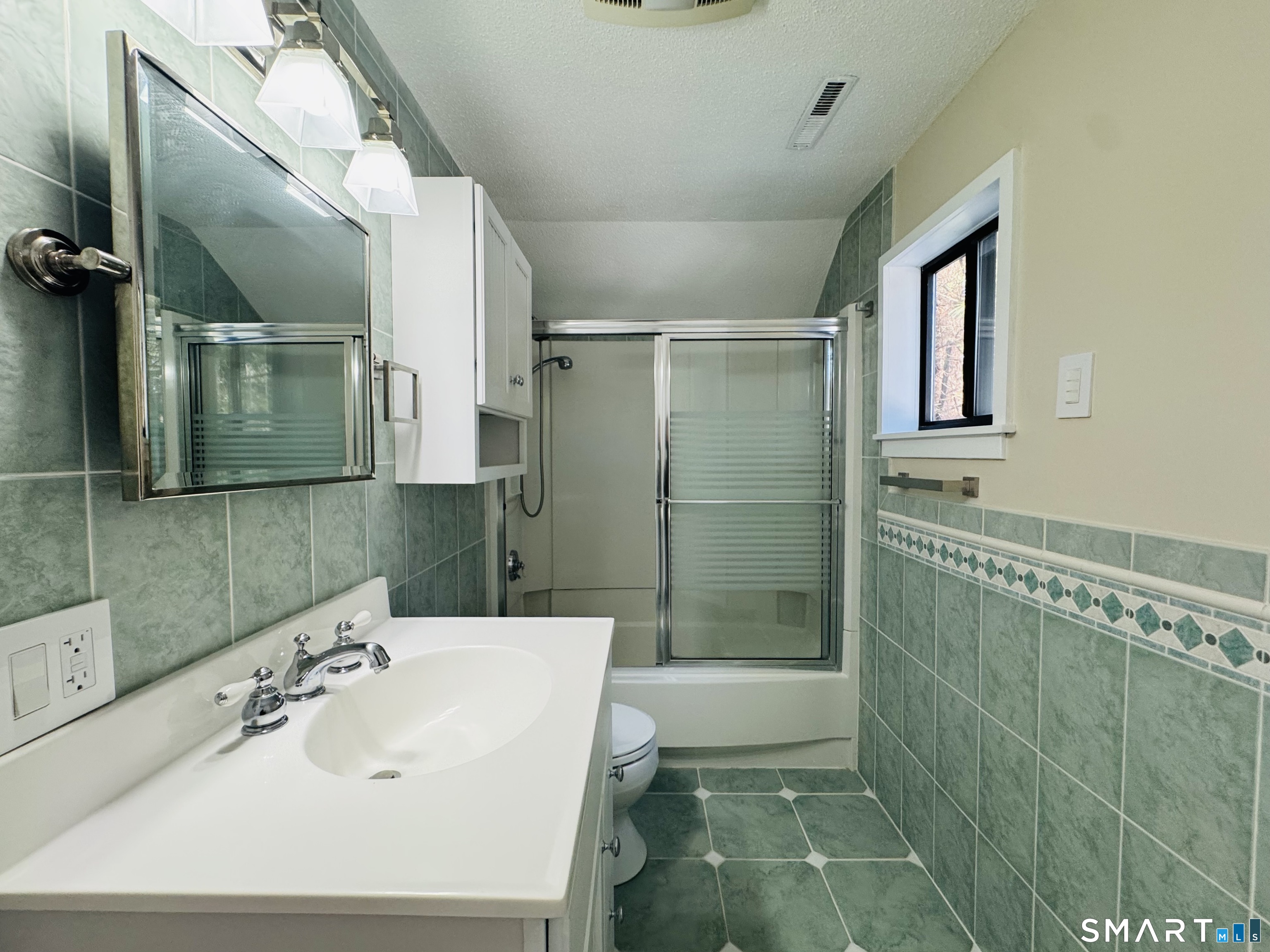2 Highland Square, Unit 2 Avon, CT 06001 - Photo 33 of 40 a bathroom with a sink a toilet and shower