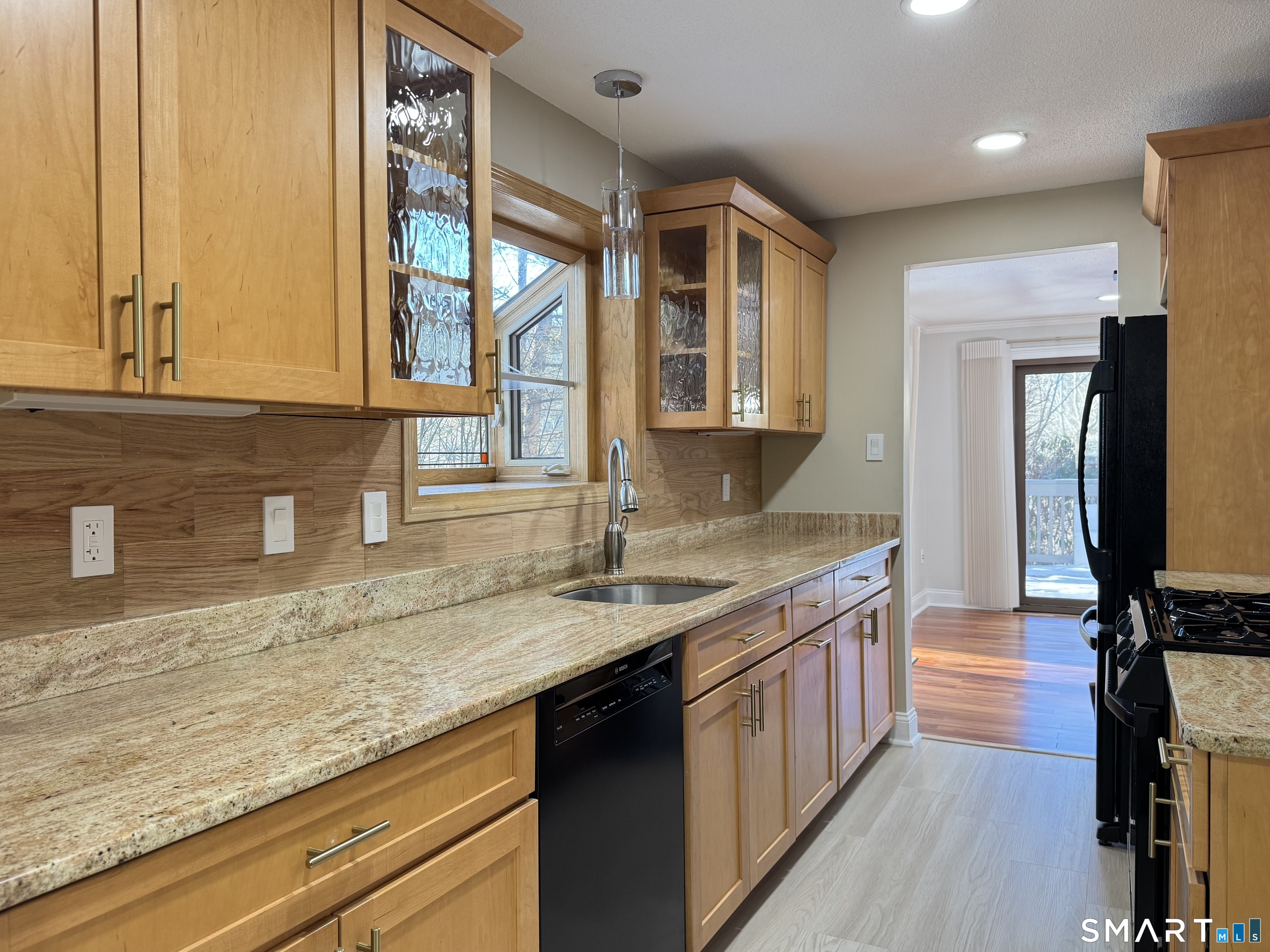 2 Highland Square, Unit 2 Avon, CT 06001 - Photo 5 of 40 a kitchen with granite countertop a sink a counter space and cabinets