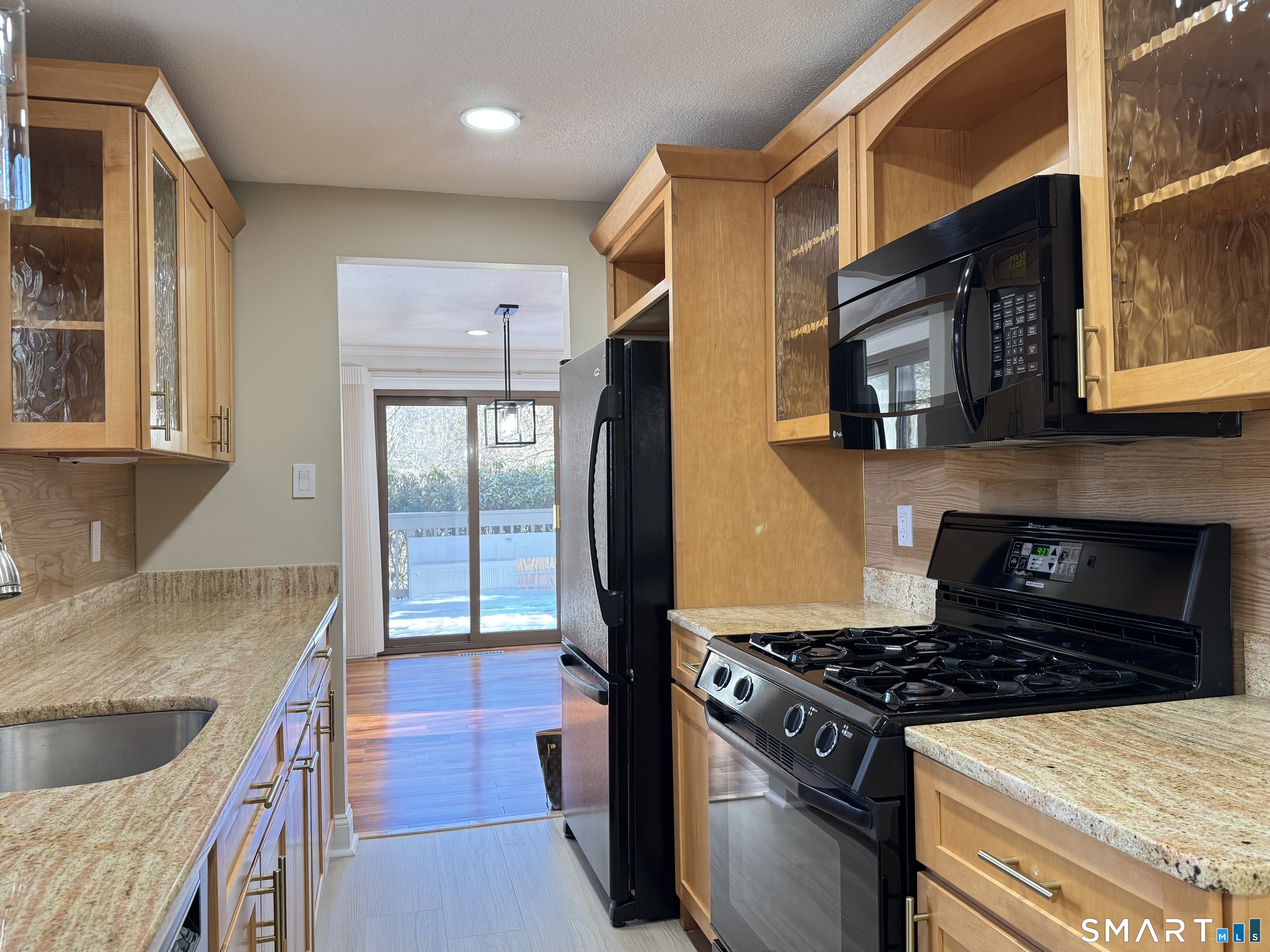2 Highland Square, Unit 2 Avon, CT 06001 - Photo 6 of 40 a kitchen with granite countertop a stove and a sink
