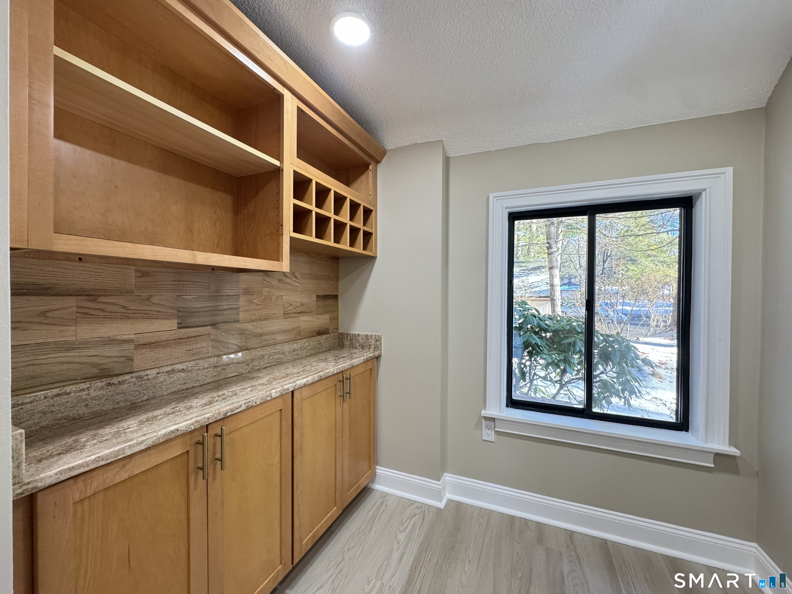 2 Highland Square, Unit 2 Avon, CT 06001 - Photo 8 of 40 a kitchen with a window and wooden floor