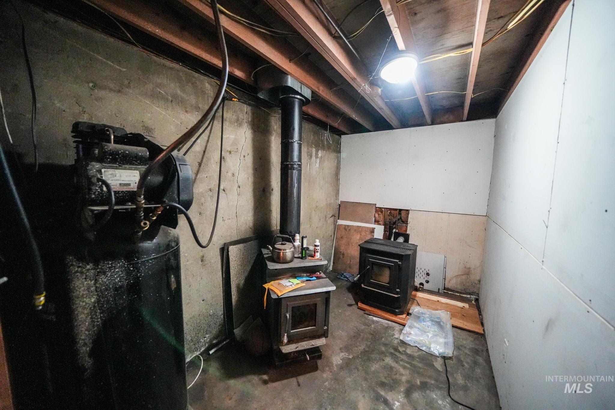 10 Main Street South Pierce, ID 83546 - Photo 20 of 27 Unfinished basement featuring a wood stove and a water softener system