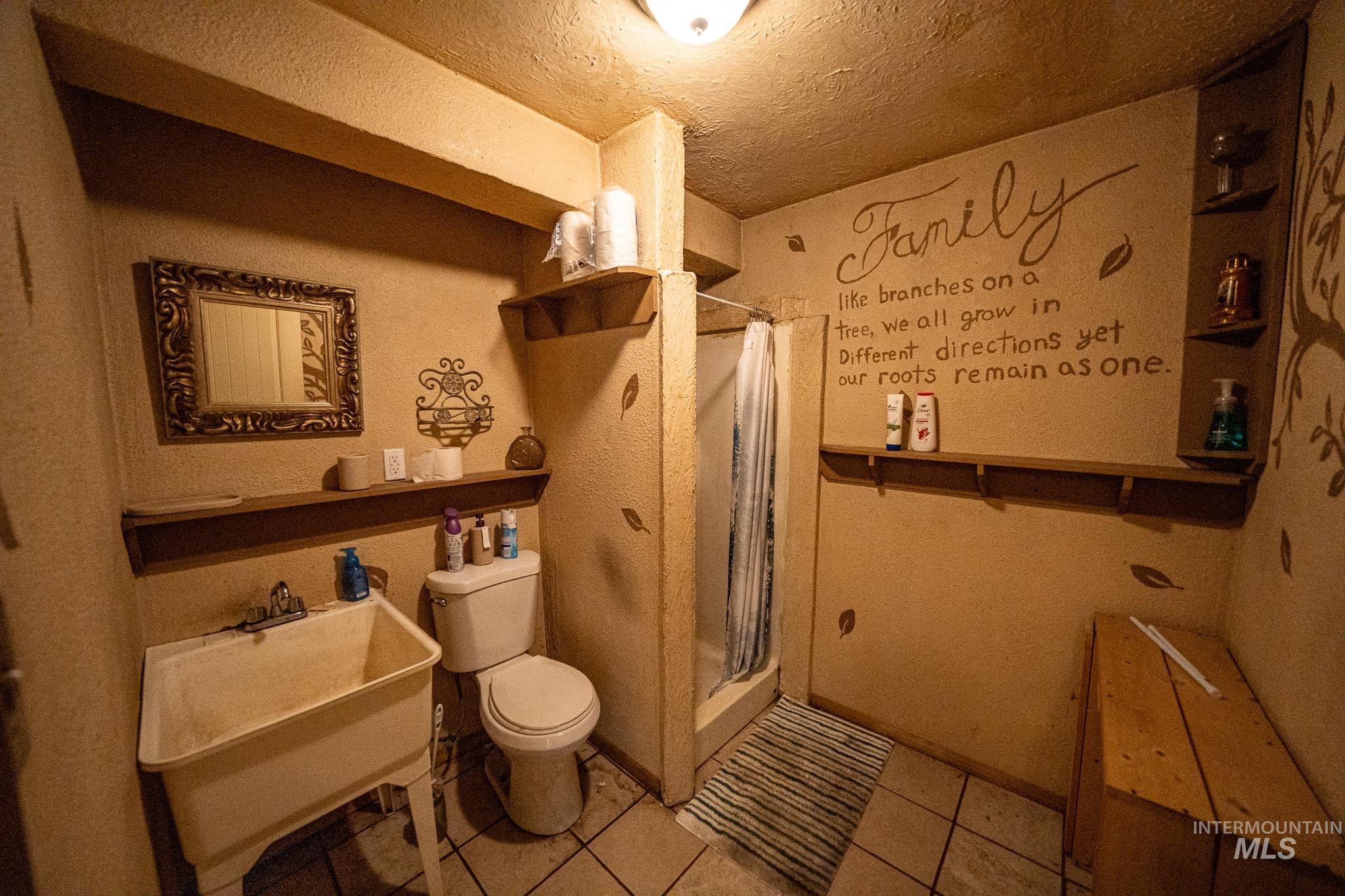 10 Main Street South Pierce, ID 83546 - Photo 22 of 27 Full bath featuring a stall shower, light tile patterned floors, and a textured ceiling