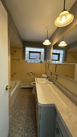 a bathroom with a sink a toilet and mirror