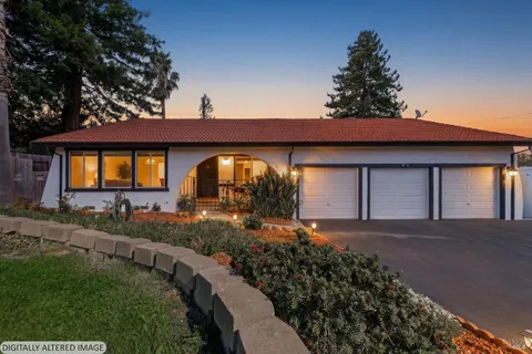a front view of a house with garden