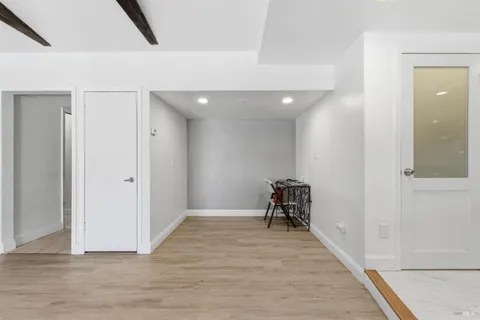 a view of a room with wooden floor and furniture