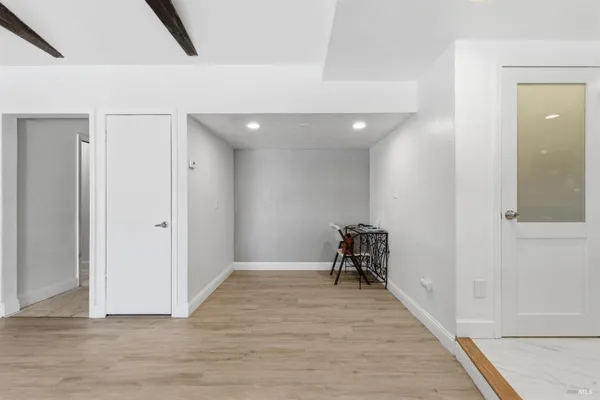 a view of a room with wooden floor and furniture