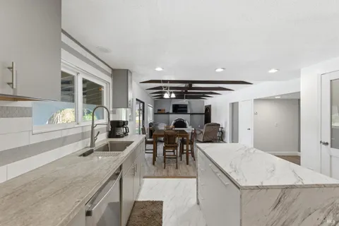 a kitchen with a stove a sink and a refrigerator