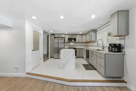 a kitchen with stainless steel appliances granite countertop a refrigerator sink and cabinets