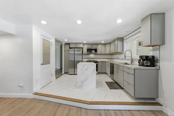 a kitchen with stainless steel appliances granite countertop a refrigerator sink and cabinets