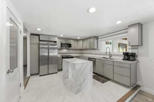 a kitchen with counter top space cabinets and stainless steel appliances