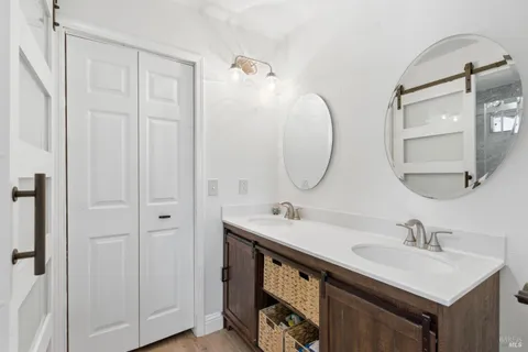 a bathroom with 2 sink and a mirror