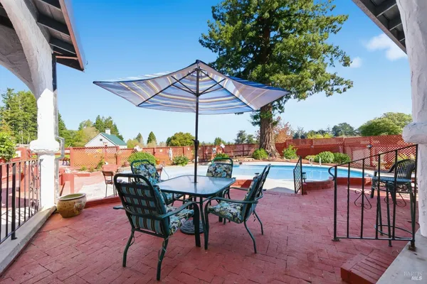 an outdoor space with furniture and umbrella