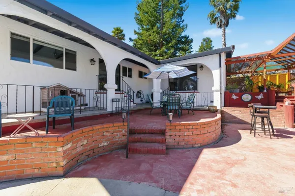 a view of a house with swimming pool and sitting area