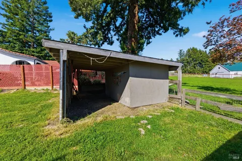 a view of yard with grass & house