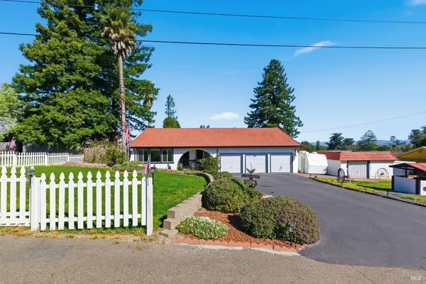 a front view of a house with a garden